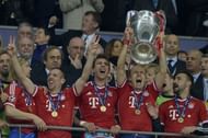 Bayern Munich's midfielder Arjen Robben lifts the Champions League trophy at Wembley Stadium in London on May 25, 2013